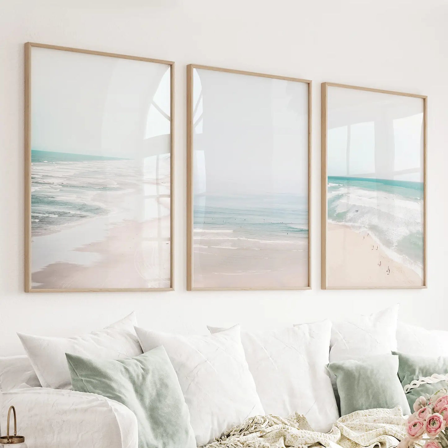 Blue ocean beach and waves. 3 piece summer wall art. Thin natural wood frames above couch in living room
