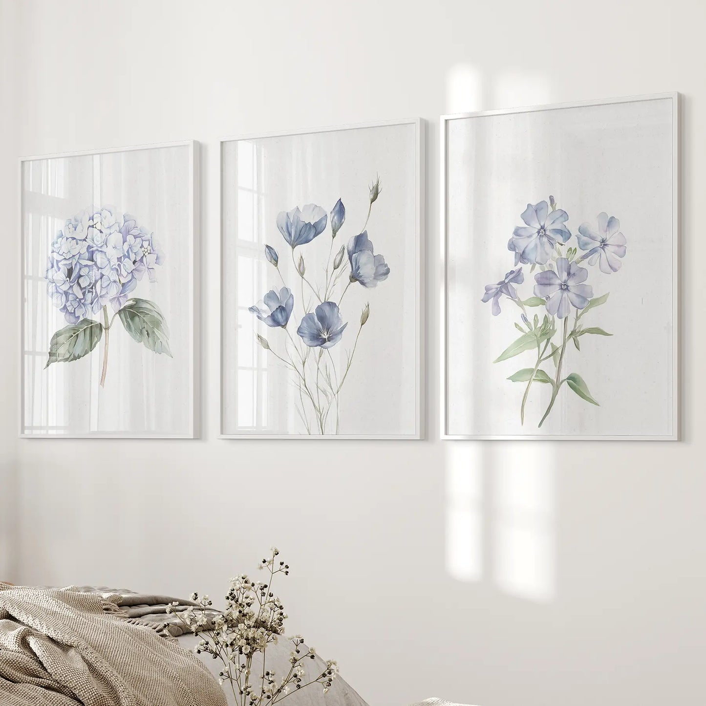 Minimalist floral poster, blue cottage core art decor. White frames above the bed.