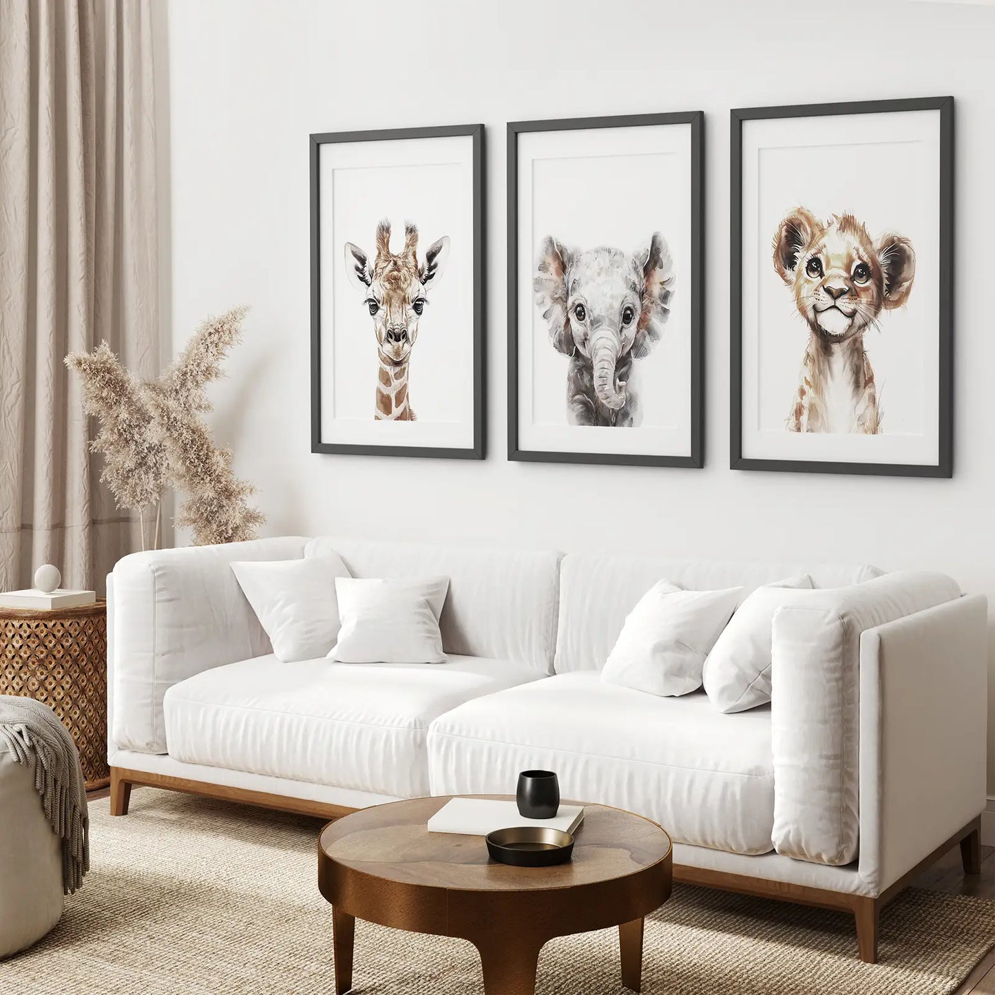 Modern nursery wall decor with soft watercolor paintings of baby safari animals. Black frames with mat over the couch.