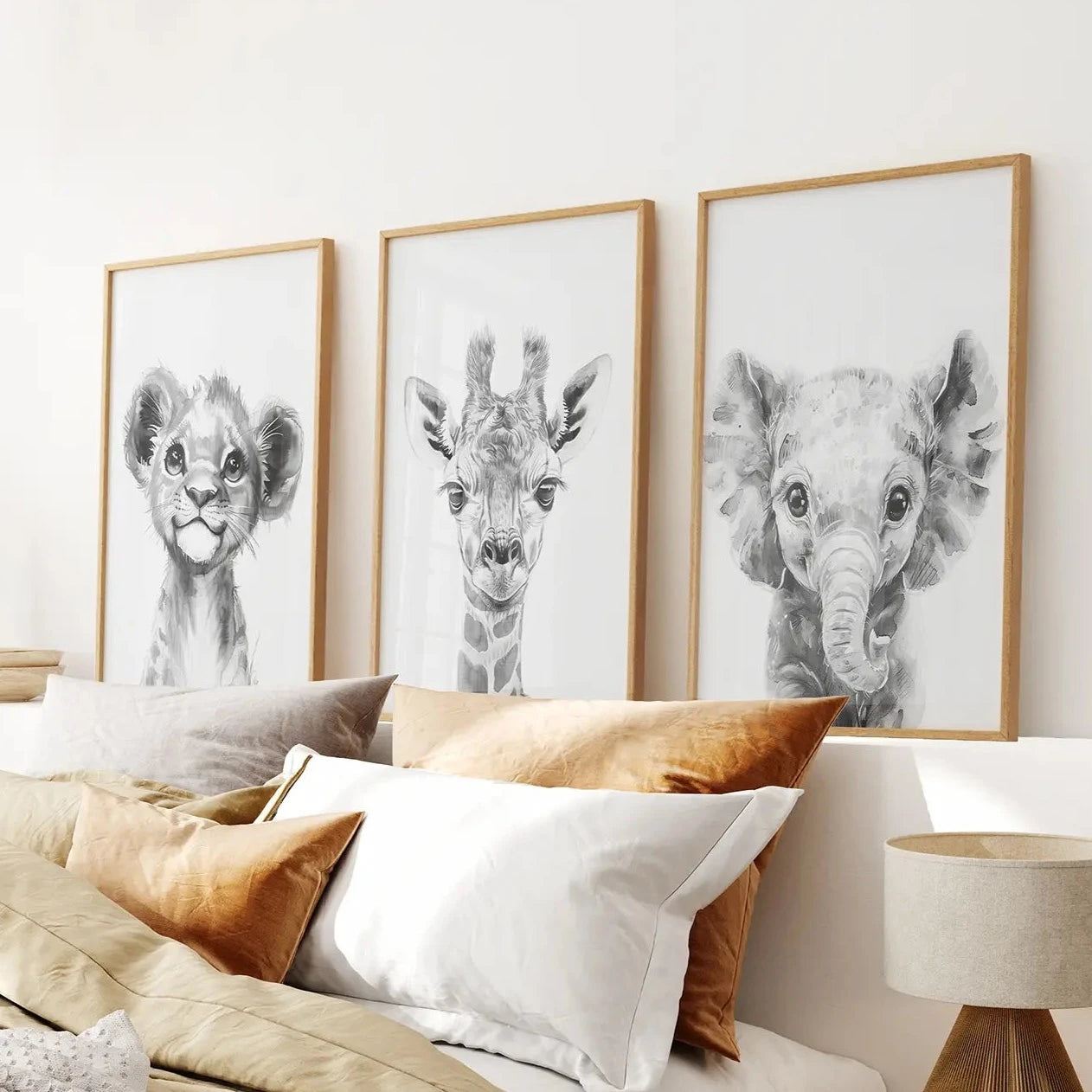 Adorable safari animal prints featuring baby lion, giraffe, and elephant. Thinwood frames over the bed.