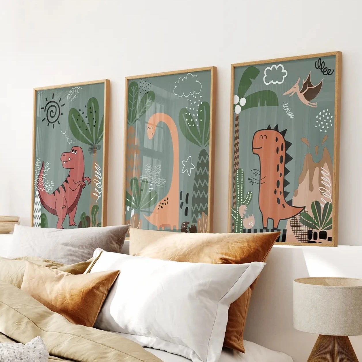 Kids dinosaur wall decor trio in earthy tones for nursery or playroom. Thinwood frames over the bed.