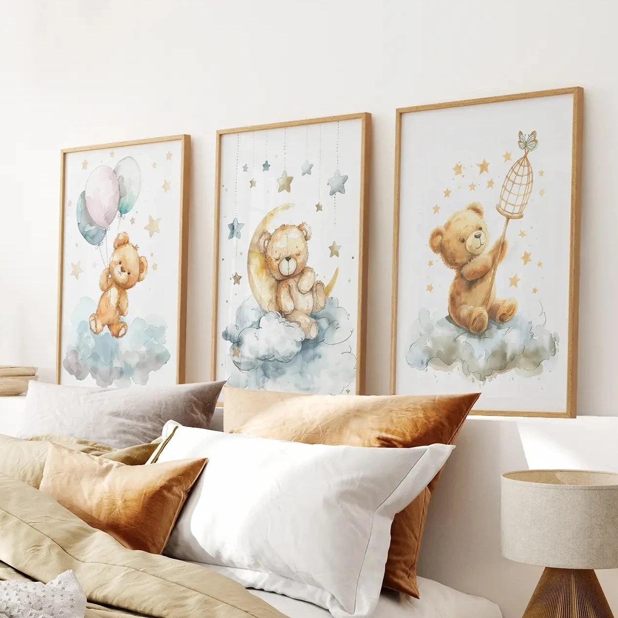 Teddy bear nursery wall art set of 3 watercolor prints on clouds and stars. Thinwood frames over the bed.