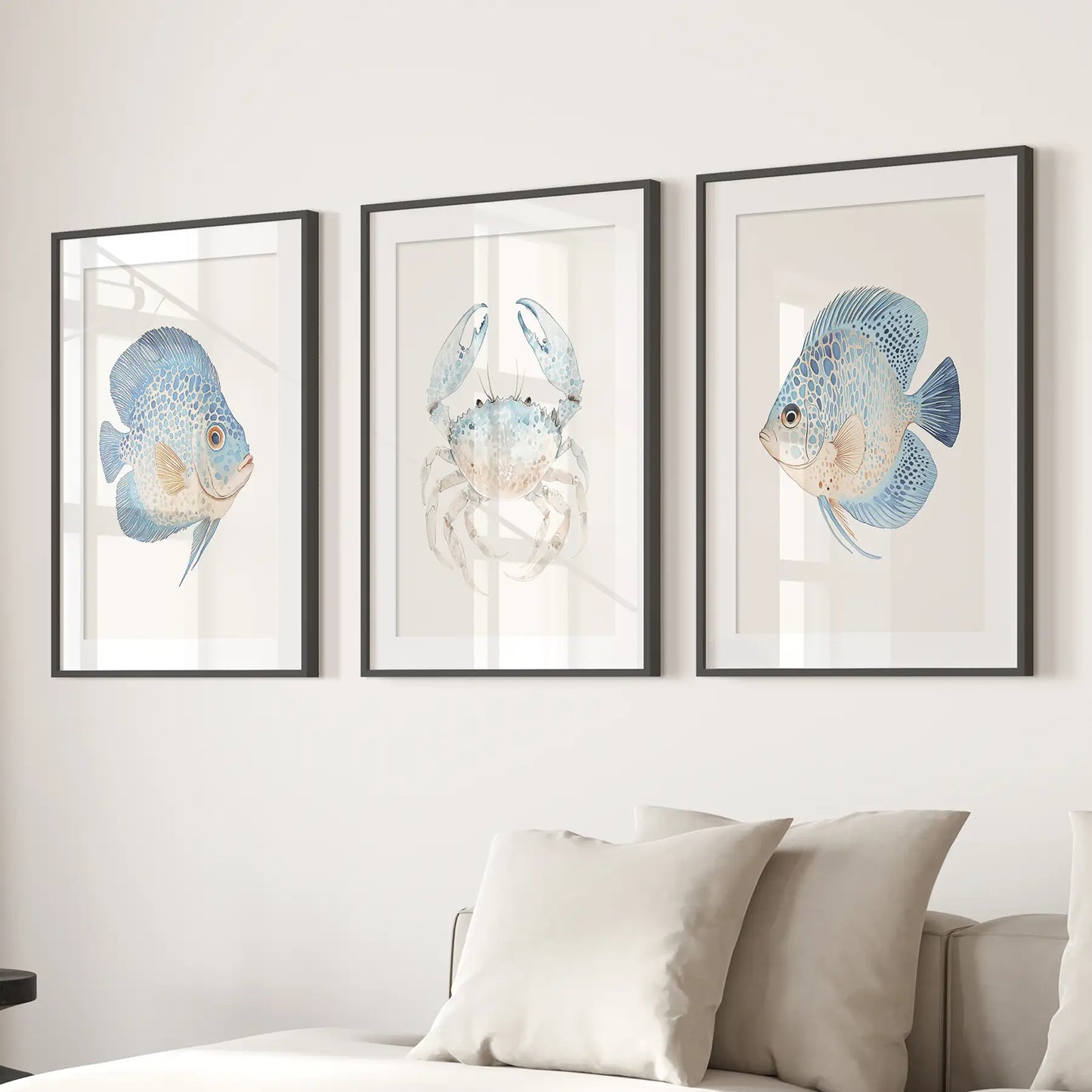 Watercolor crab and fish posters. Nautical apartment decor. Black frames with mat above the sofa.