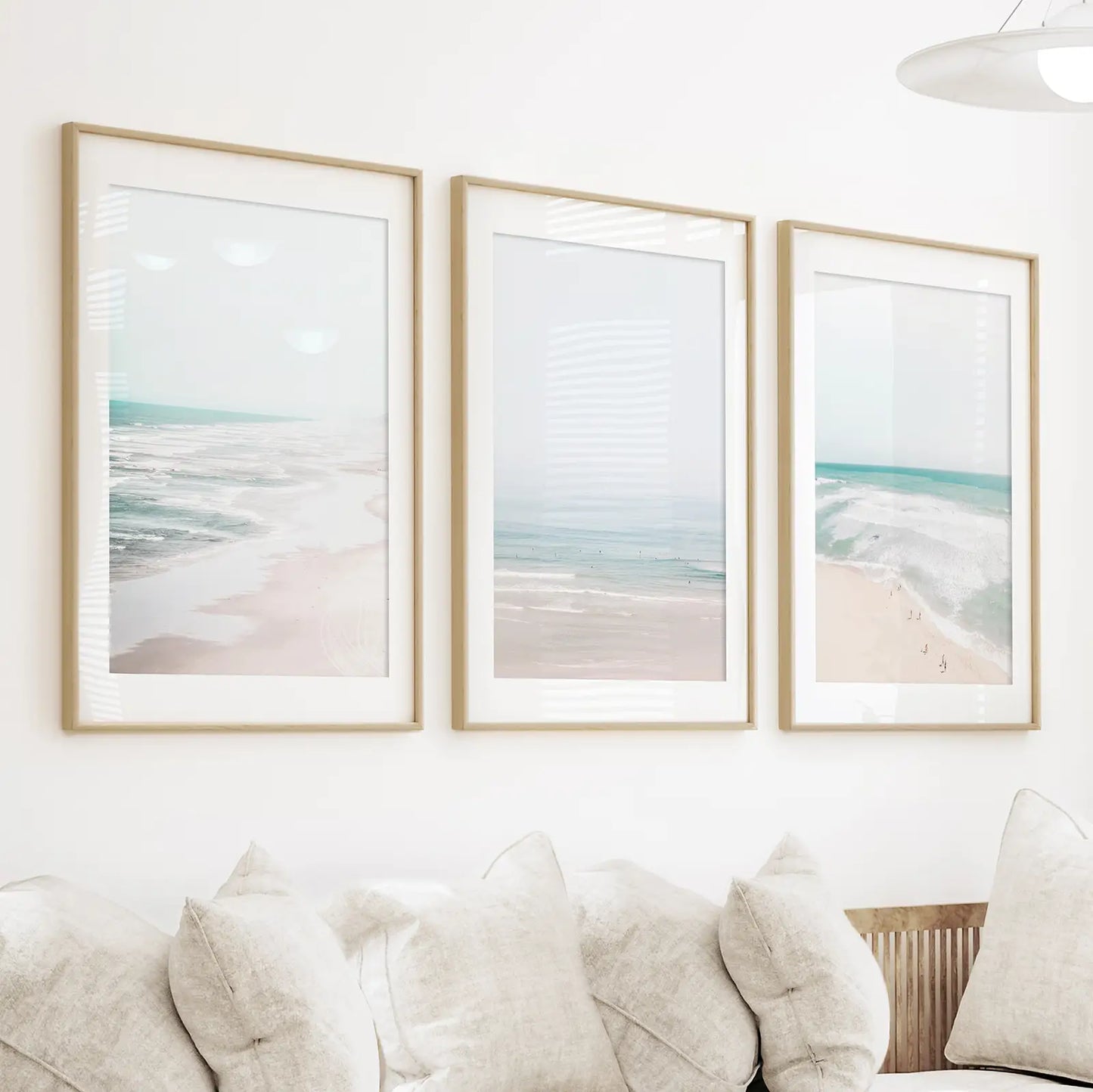 Coastal set of 3 Prints. Blue waves and beige sand ocean beach. Thin natural wood frames with mat in the dining room