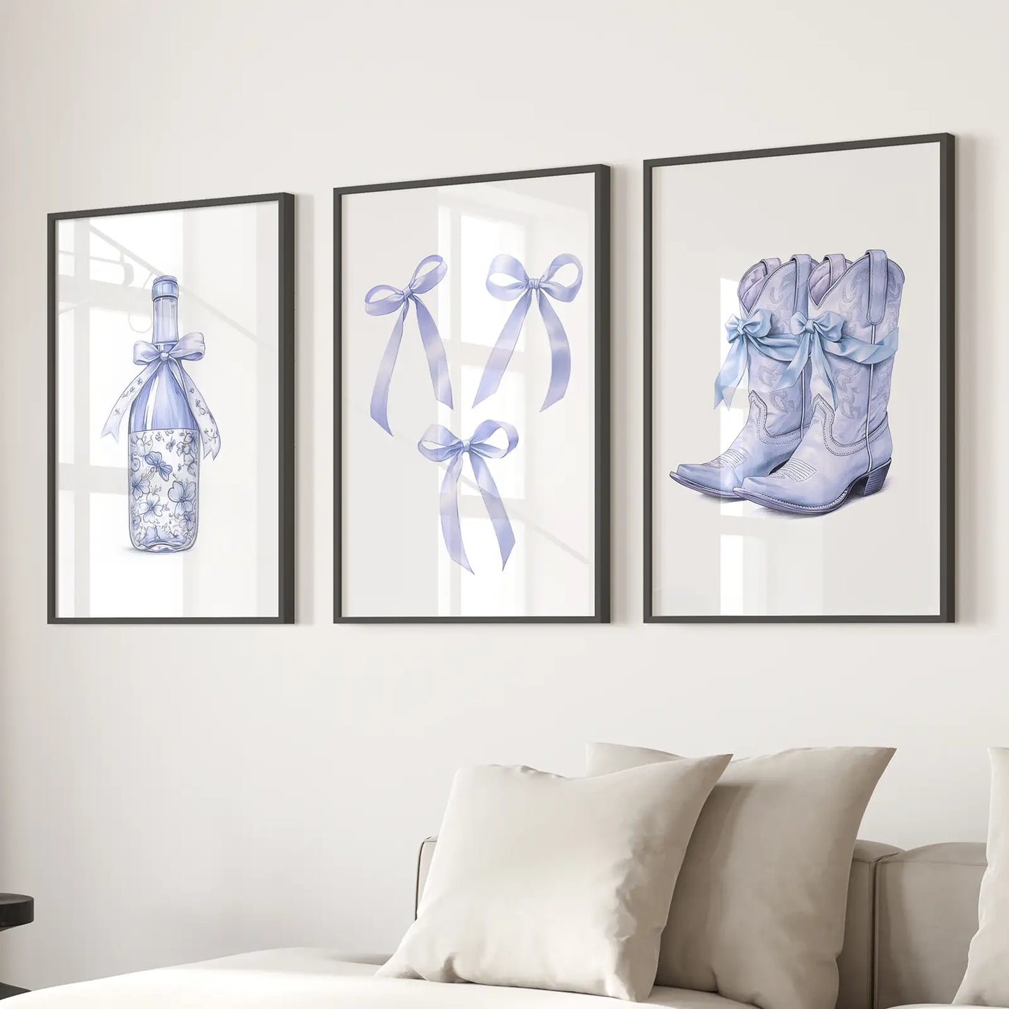 Set of 3 blue western wall art prints with cowboy boots, floral wine bottle, and ribbon bows. Black frames for living room.
