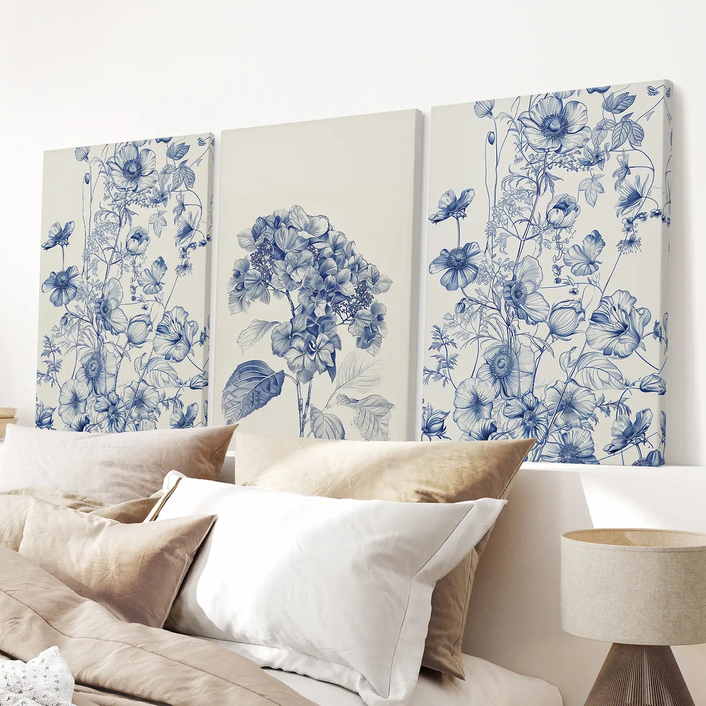 Hydrangea and botanical art prints in blue and white, set of 3. Stretched canvas above the bed.