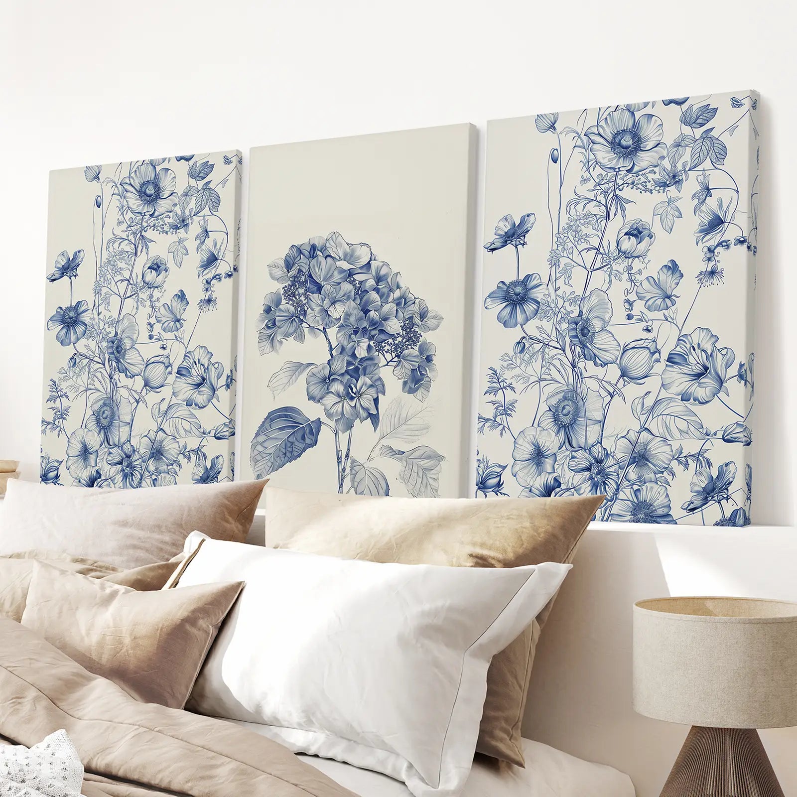 Hydrangea and botanical art prints in blue and white, set of 3. Stretched canvas above the bed.