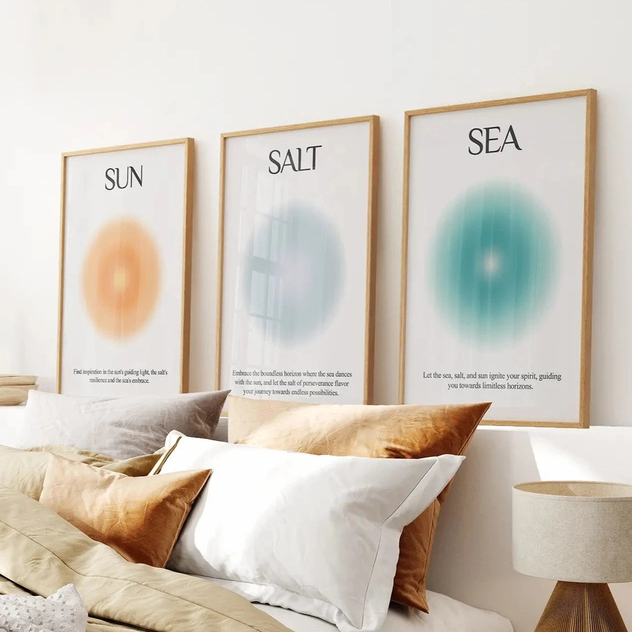 Minimalist Sun Salt Sea wall art set of 3 prints in warm coastal colors. Thinwood frames over the bed.