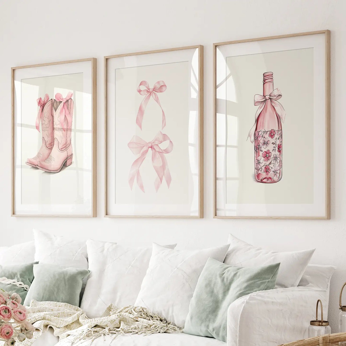 Coquette champagne bottle print pink wall art. Thinwood frames with mat over the couch.