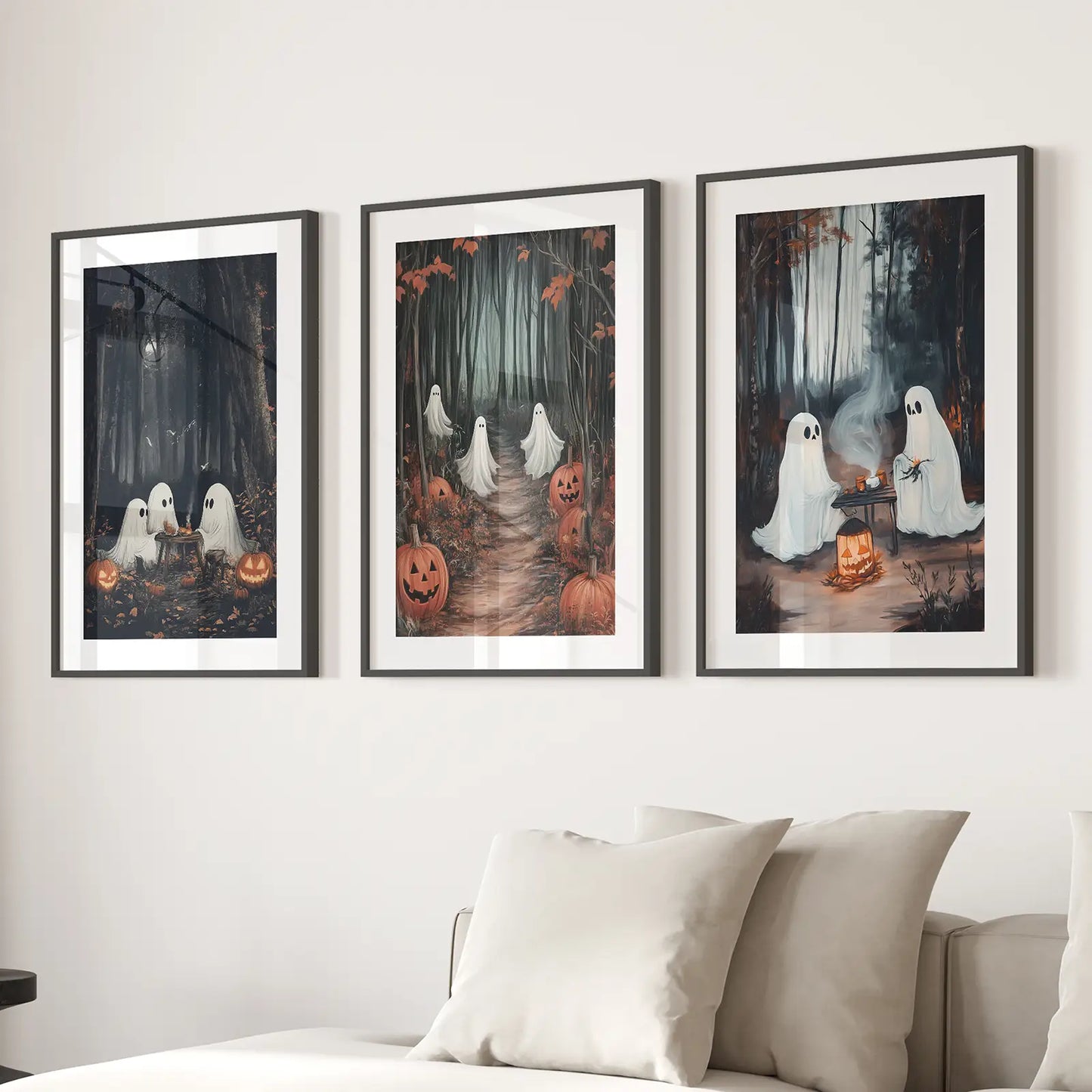 Whimsical ghost artwork set of 3 framed prints for seasonal spooky decor. Black frames with mat above the sofa.