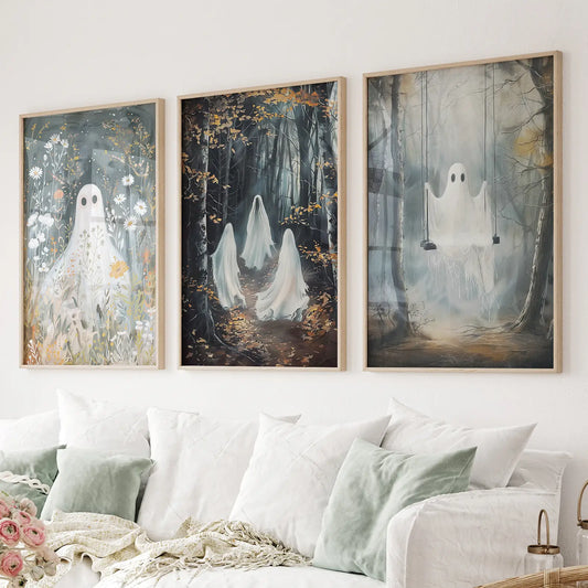 Ghost wall art set of 3 with floral ghost, forest spirits, and swing in misty woods. Thinwood frames above the sofa.