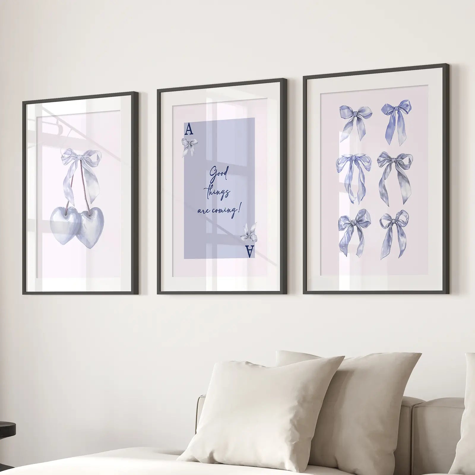 Motivational wall art with bows and silver hearts for modern decor. Black frames with mat  over the couch.