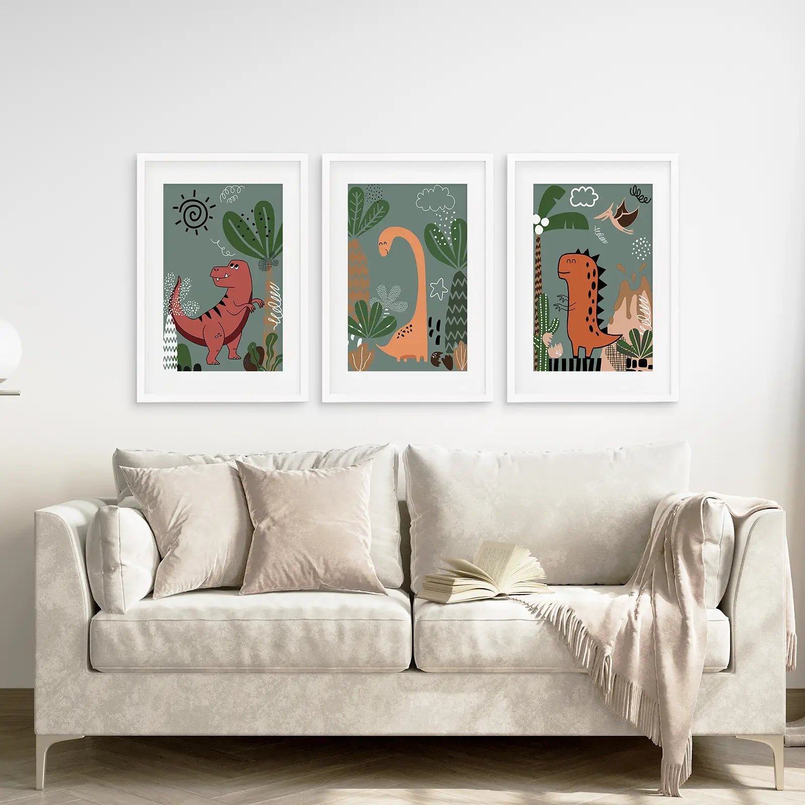 Funny dinosaur illustrations in soft colors, wall art prints for baby room. White frames with mat above the sofa.