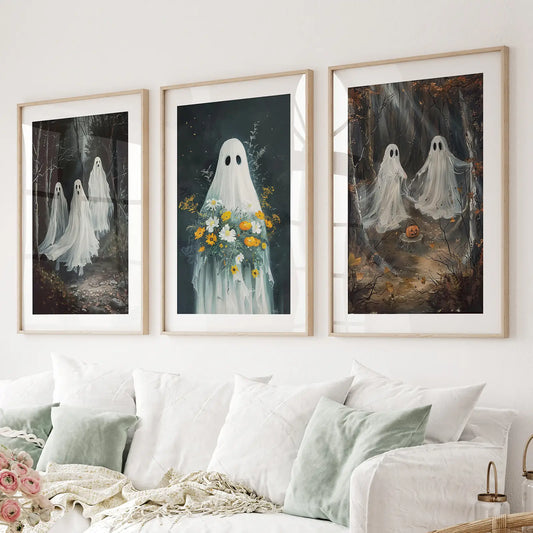 Halloween ghost wall art set of 3 prints with floral bouquet and spooky forest scenes. Thinwood frames with mat over the couch.