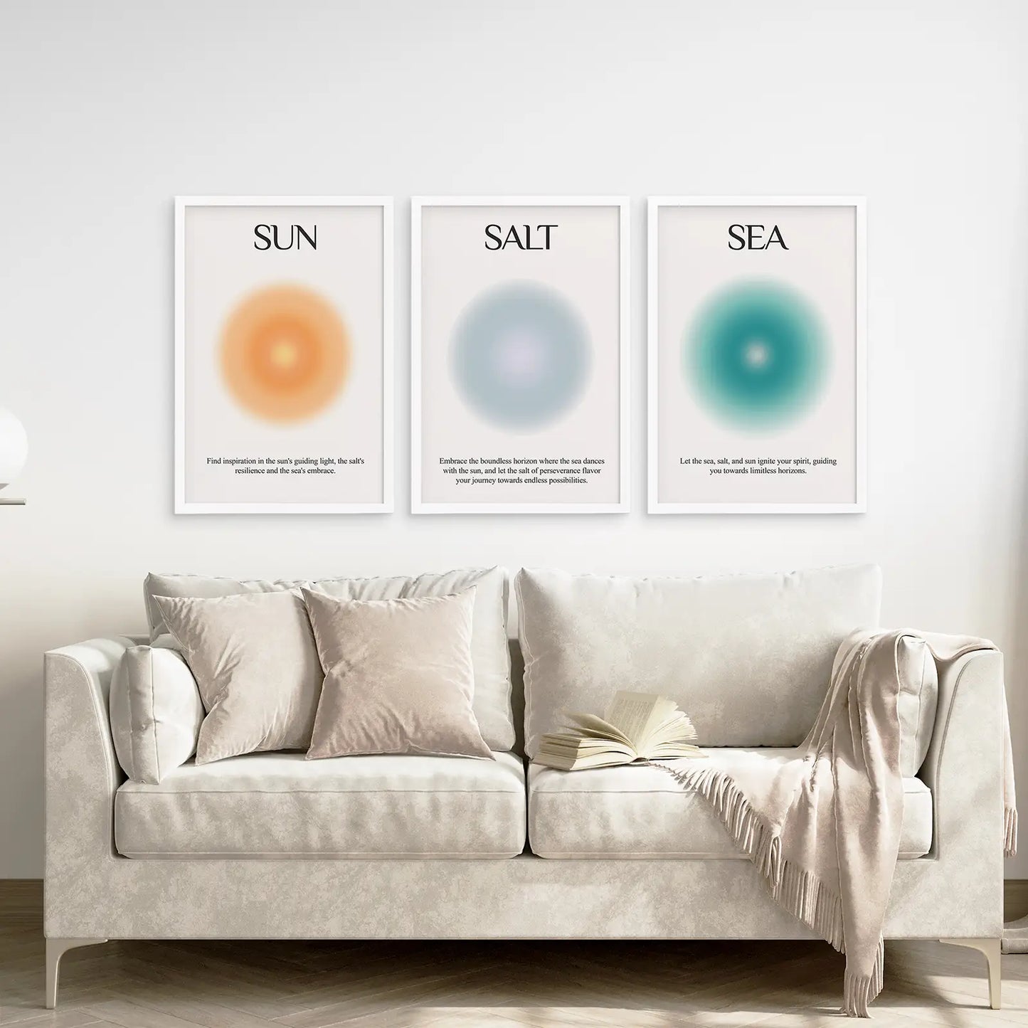 Neutral abstract wall art set of 3 with Sun Salt Sea typography. White frames above the sofa.
