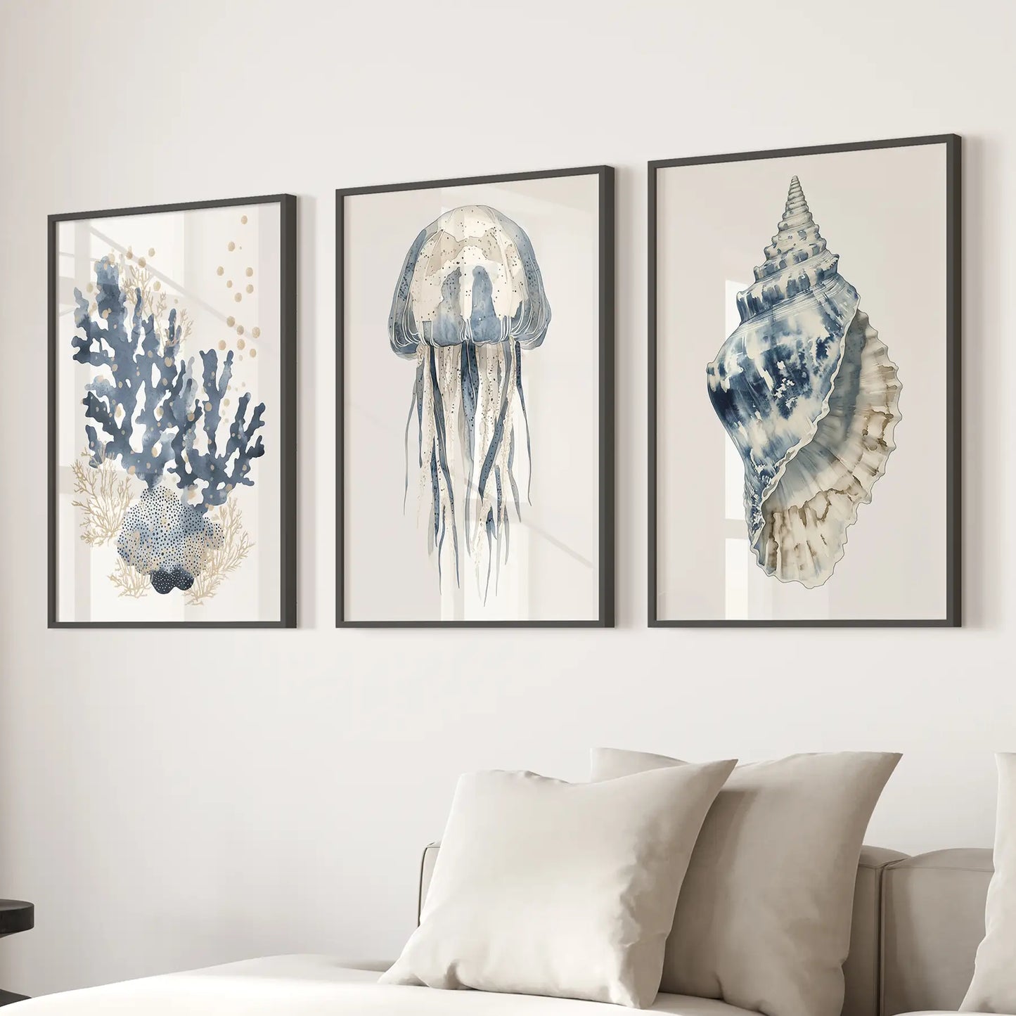 Vertical art jellyfish print blue ocean decor. Beachy watercolor prints. Black frames above the sofa.
