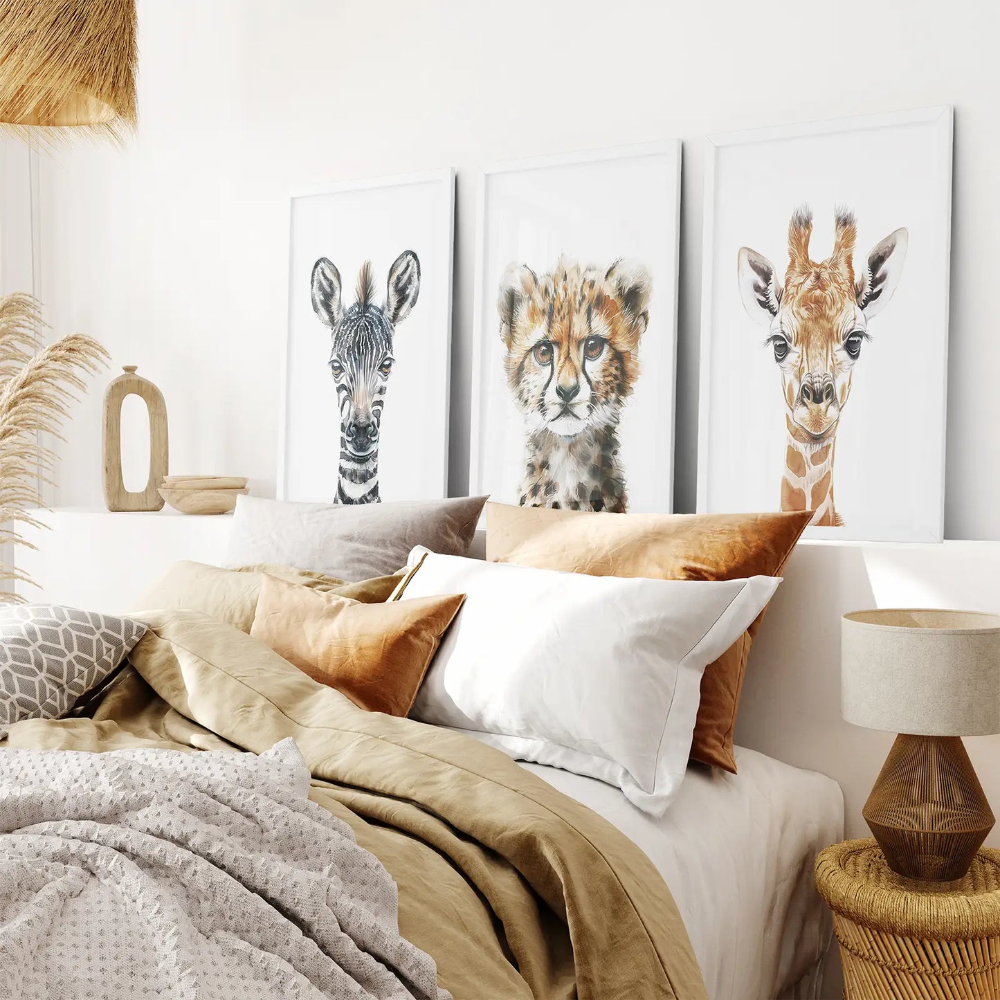 African wildlife nursery wall decor — zebra, cheetah, and giraffe portrait prints in soft tones. White frames for bedroom.