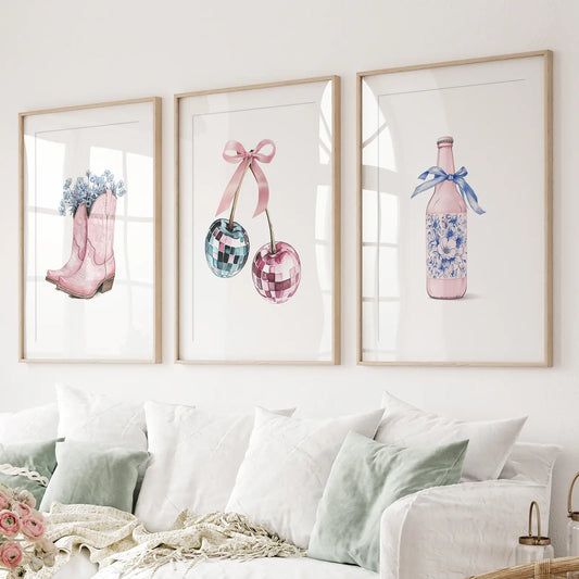 Pink cowboy boots with flowers, disco cherry balls, and floral bottle wall art set of 3 prints. Thinwood frames with mat over the couch.