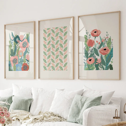 Modern floral wall art set of 3 with pink flowers and green leaves. Thinwood frames above the sofa.