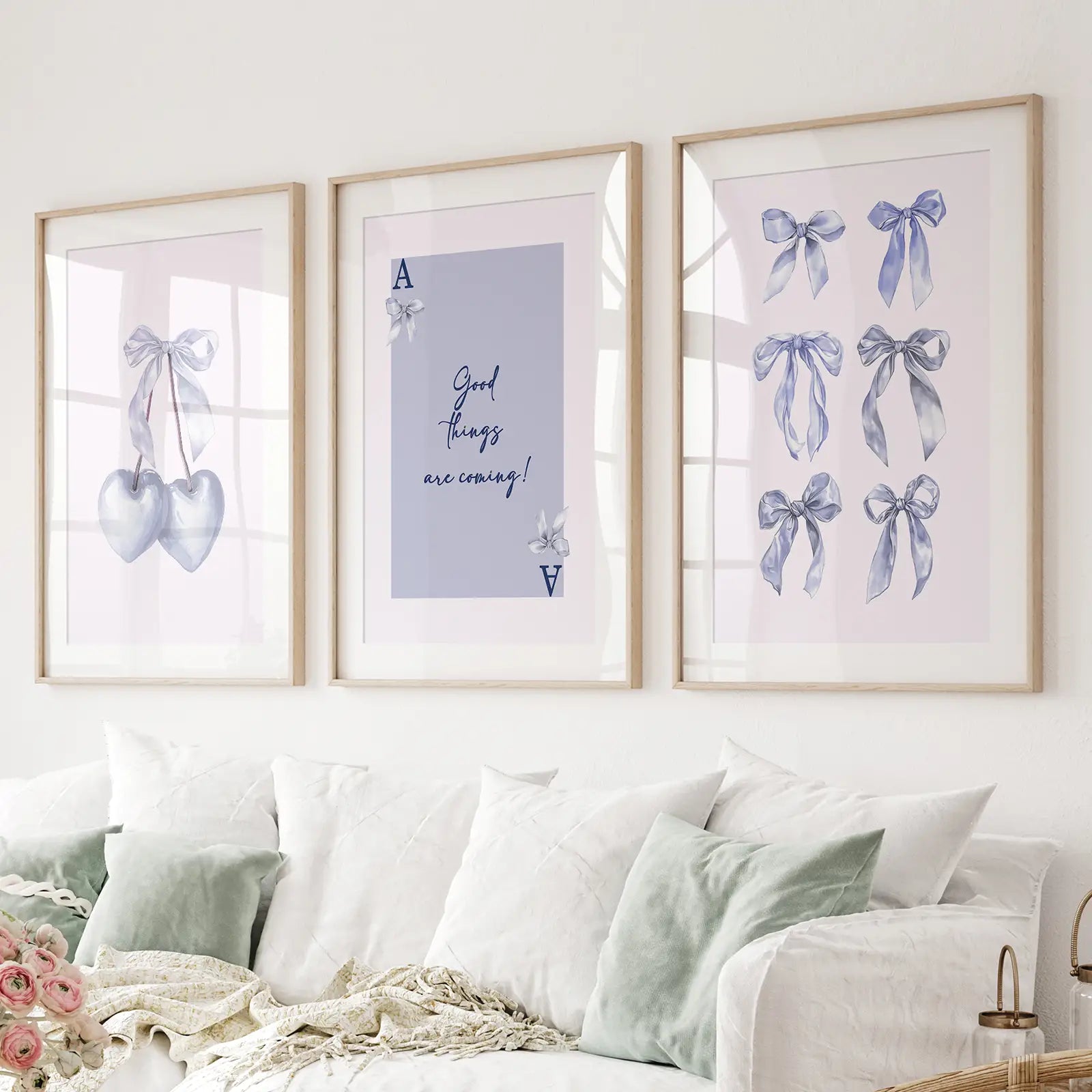 Blue wall art set of 3 with hearts, bows, and motivational quote print. Thinwood frames with mat over the couch.