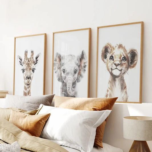 Neutral nursery wall art with watercolor baby giraffe, elephant, and lion illustrations. Thinwood frames over the bed.