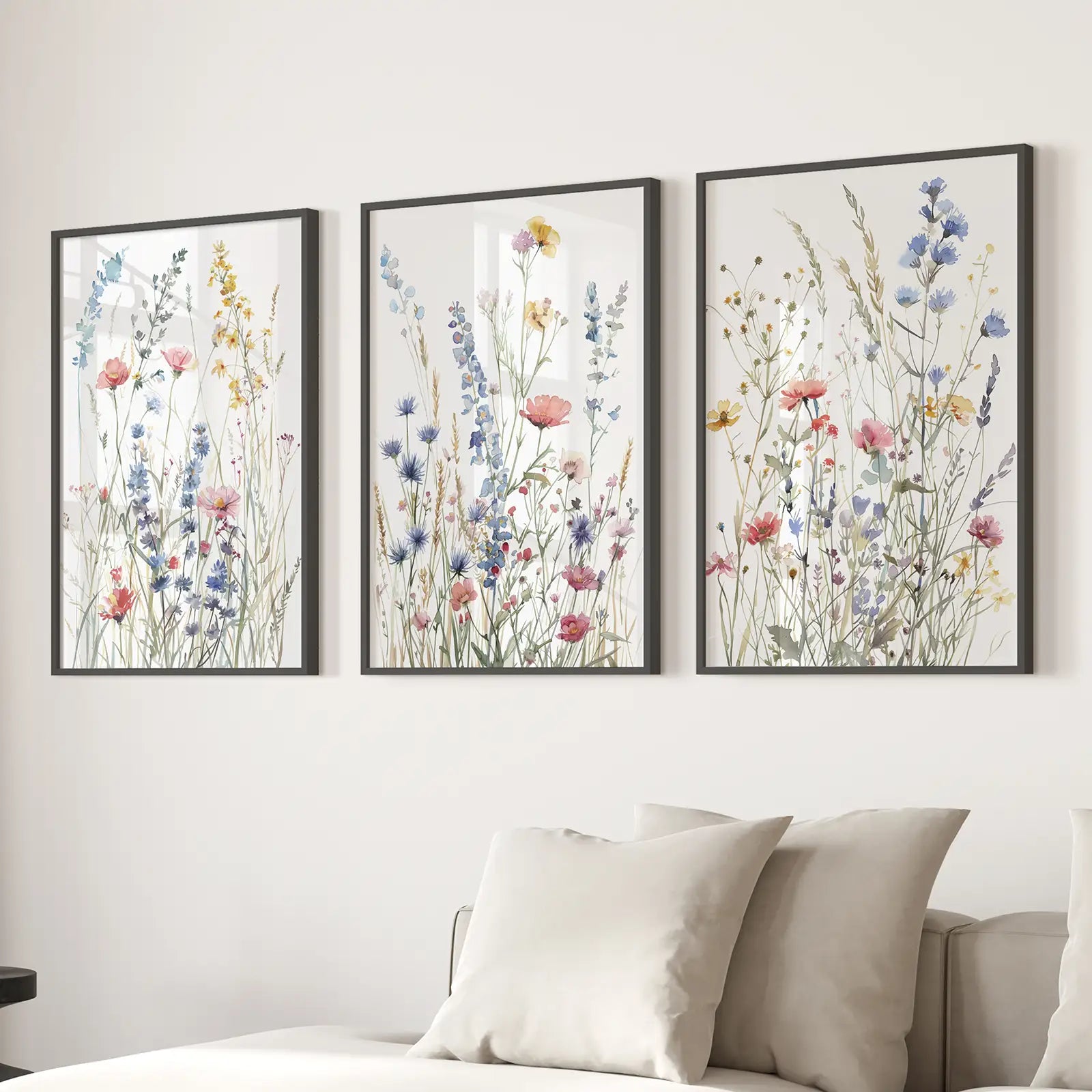Farmhouse botanical prints wildflower watercolor wall decor. Black frames over the couch.