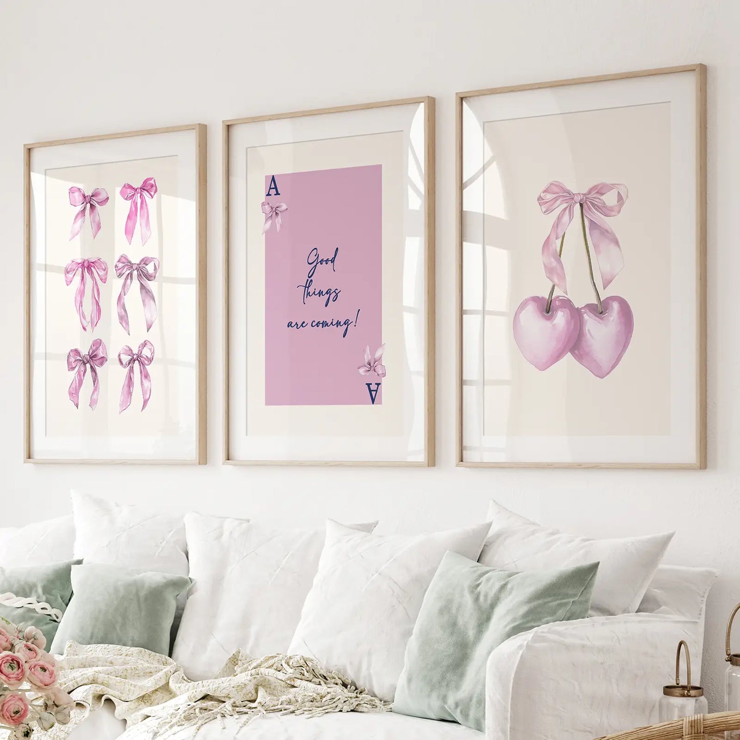Pink ribbon bow wall art set of 3 prints with motivational quote and heart cherries. Thinwood frames with mat over the couch.