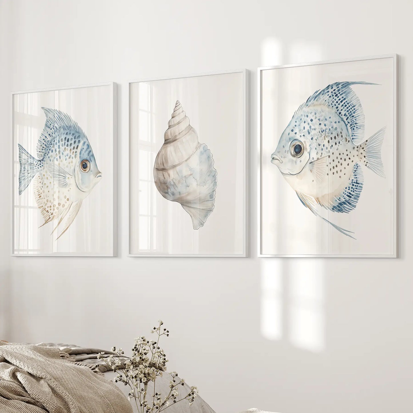 Watercolor painting large ocean posters. Pastel shell print set. White frames over the bed.