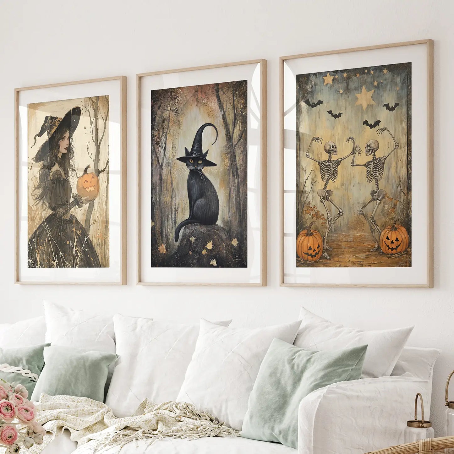 Halloween witch wall art set of 3 with black cat and dancing skeletons. Thinwood frames with mat over the couch.