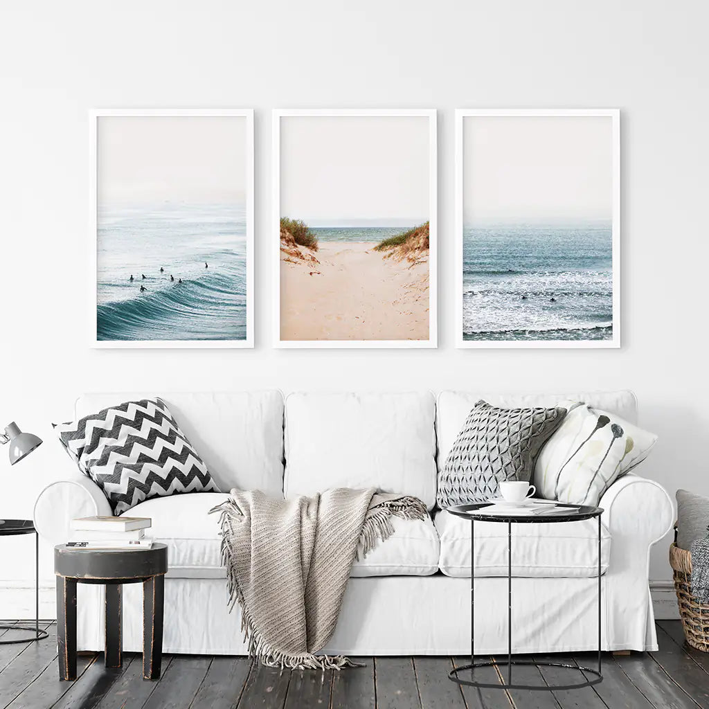 Beige Sandy Beach, Blue Ocean Waves, Surfers. Set of 3 Prints. White Frames