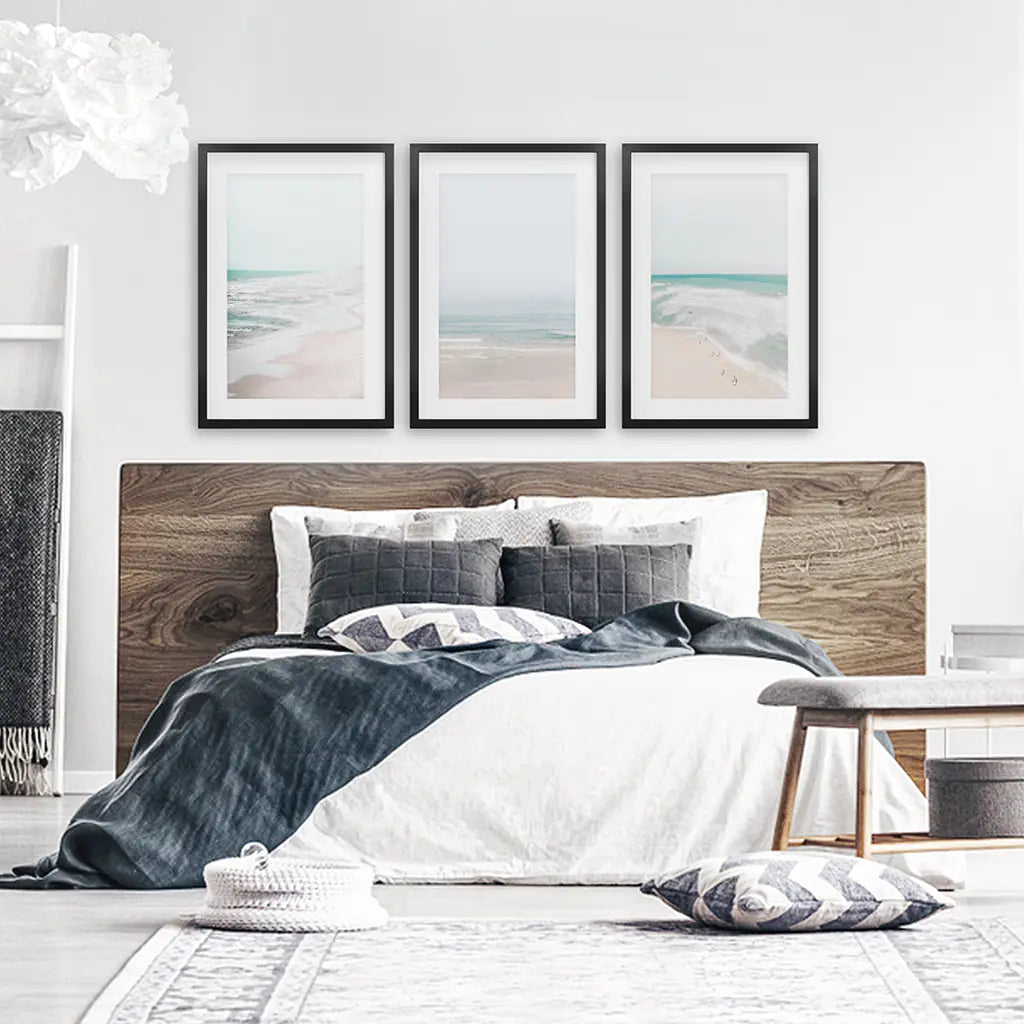 Ocean beach print set of 3. Black frames with mat above bed