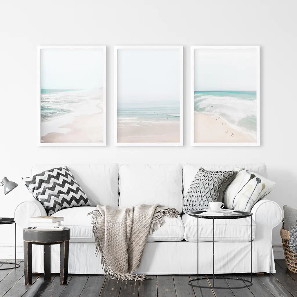 Seashore 3 piece wall decor. Summer ocean and blue waves. White frames above coach in living room.