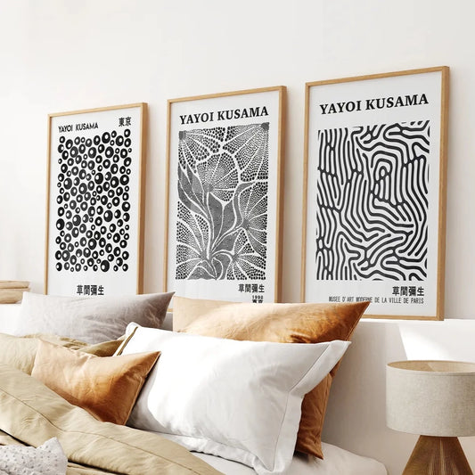 Neutral Prints Apartment Wall Decor. Thin Wood Frames Over the Bed.