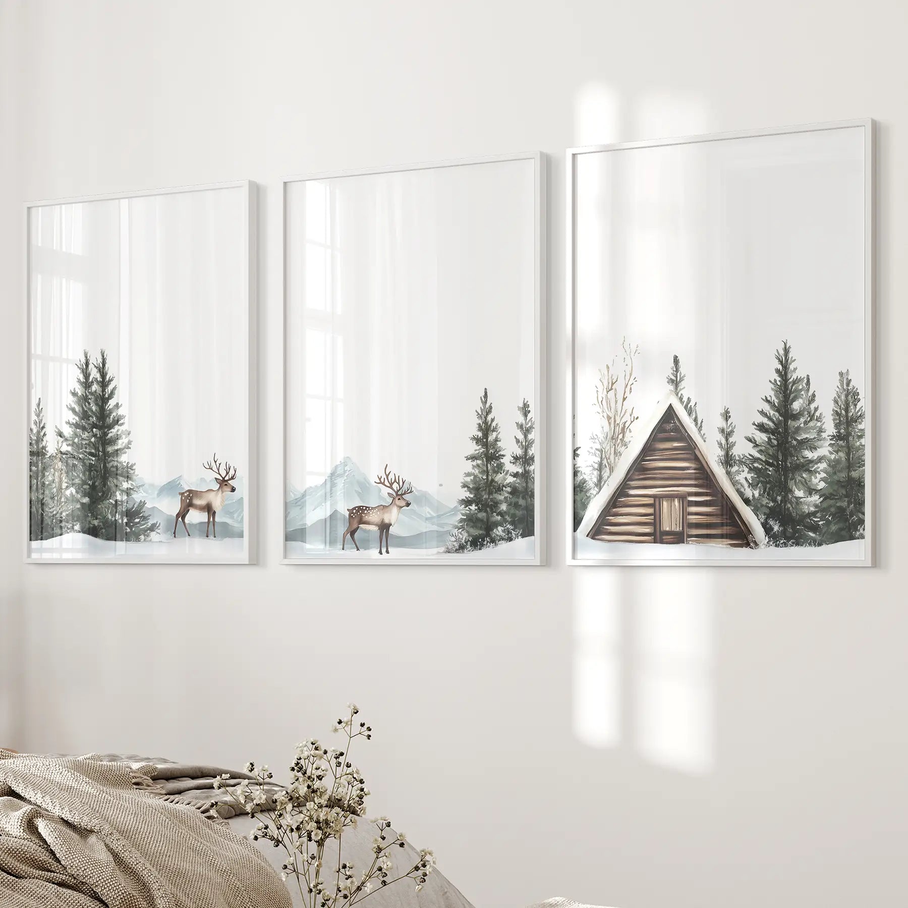 Neutral farmhouse winter wall decor art print set. White frames over the bed.