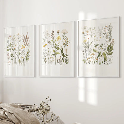 Wild plants botanical art decor. Wildflowers print set of 3. White frames above the bed.