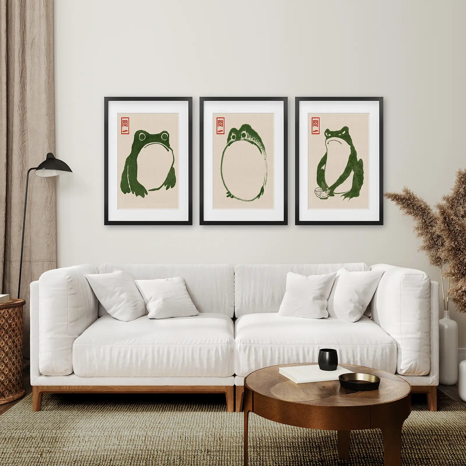 Green Frog Illustration Art Prints Set of 3. Black Frames with Mat Over the Coach.