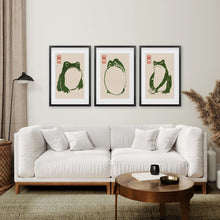 Load image into Gallery viewer, Green Frog Illustration Art Prints Set of 3. Black Frames with Mat Over the Coach.
