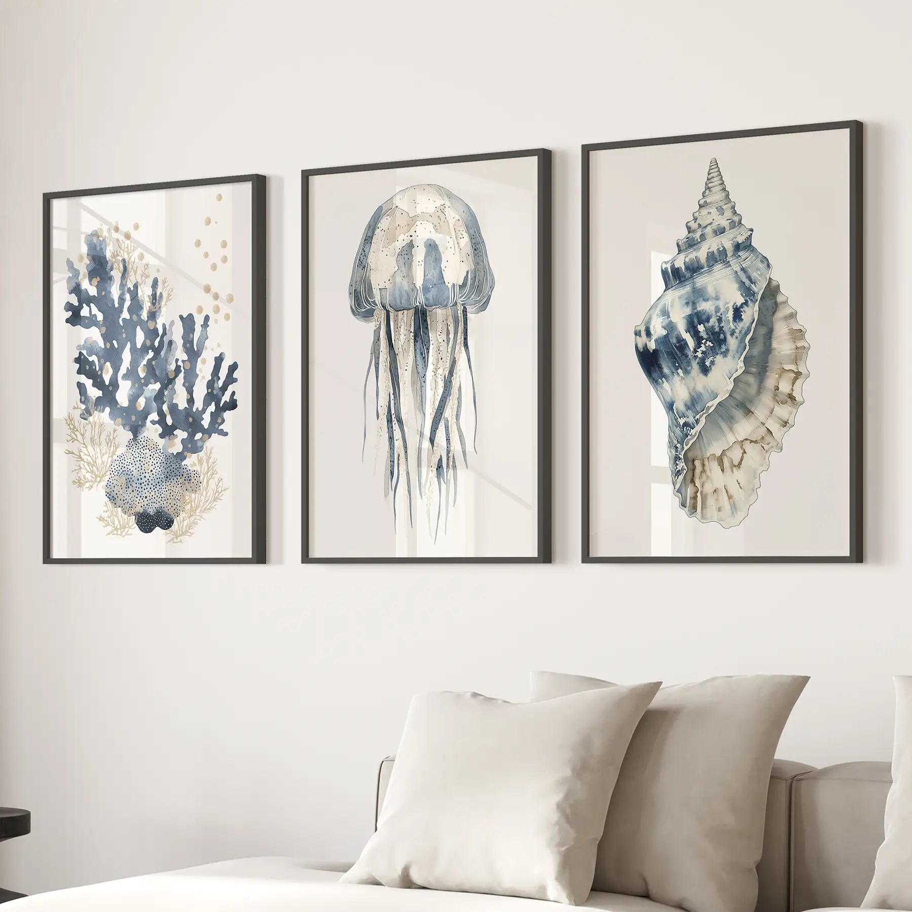 Vertical art jellyfish print blue ocean decor. Beachy watercolor prints. Black frames above the sofa.