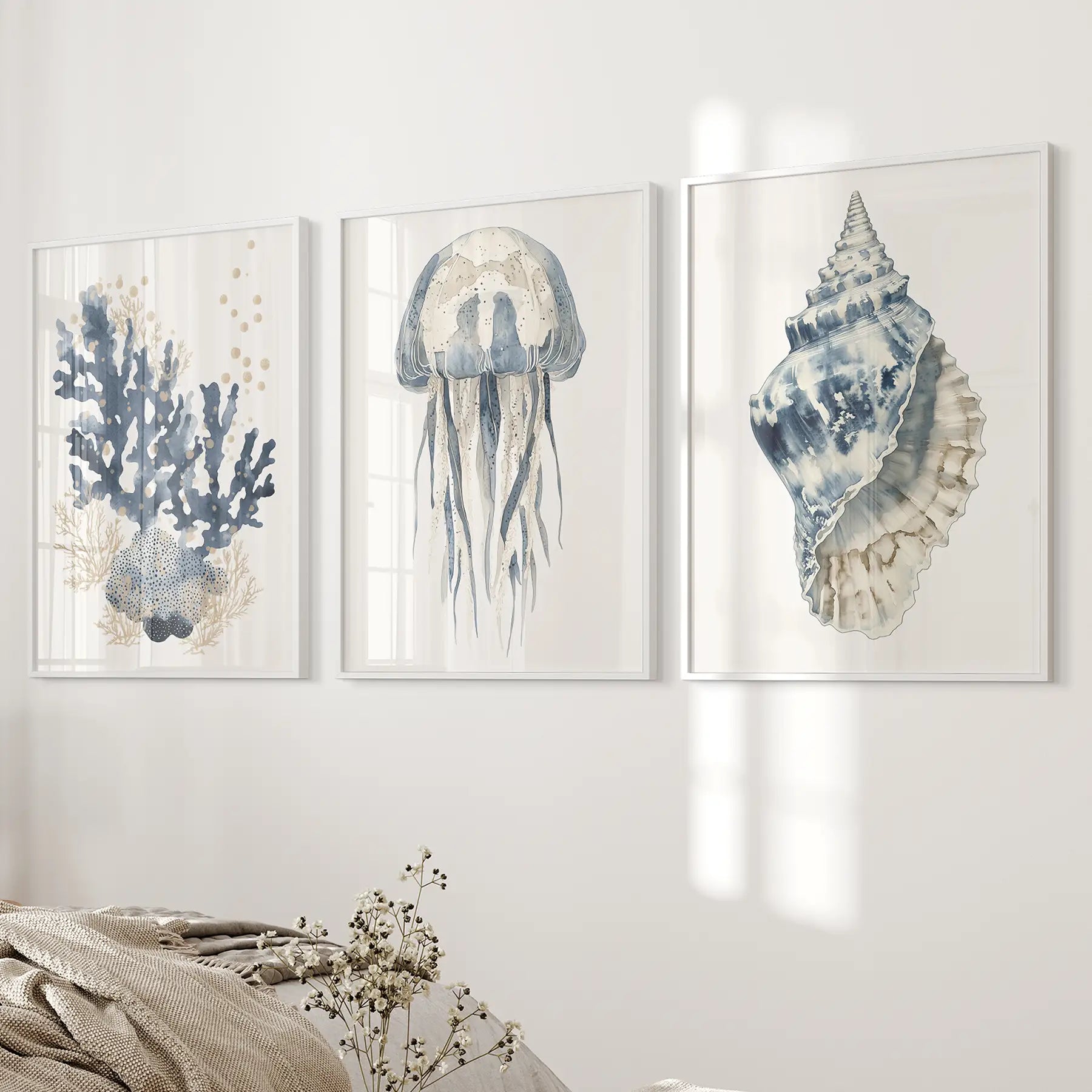 Nautical ocean beach house watercolor posters. Minimalist coastal wall decor. White frames above the bed.