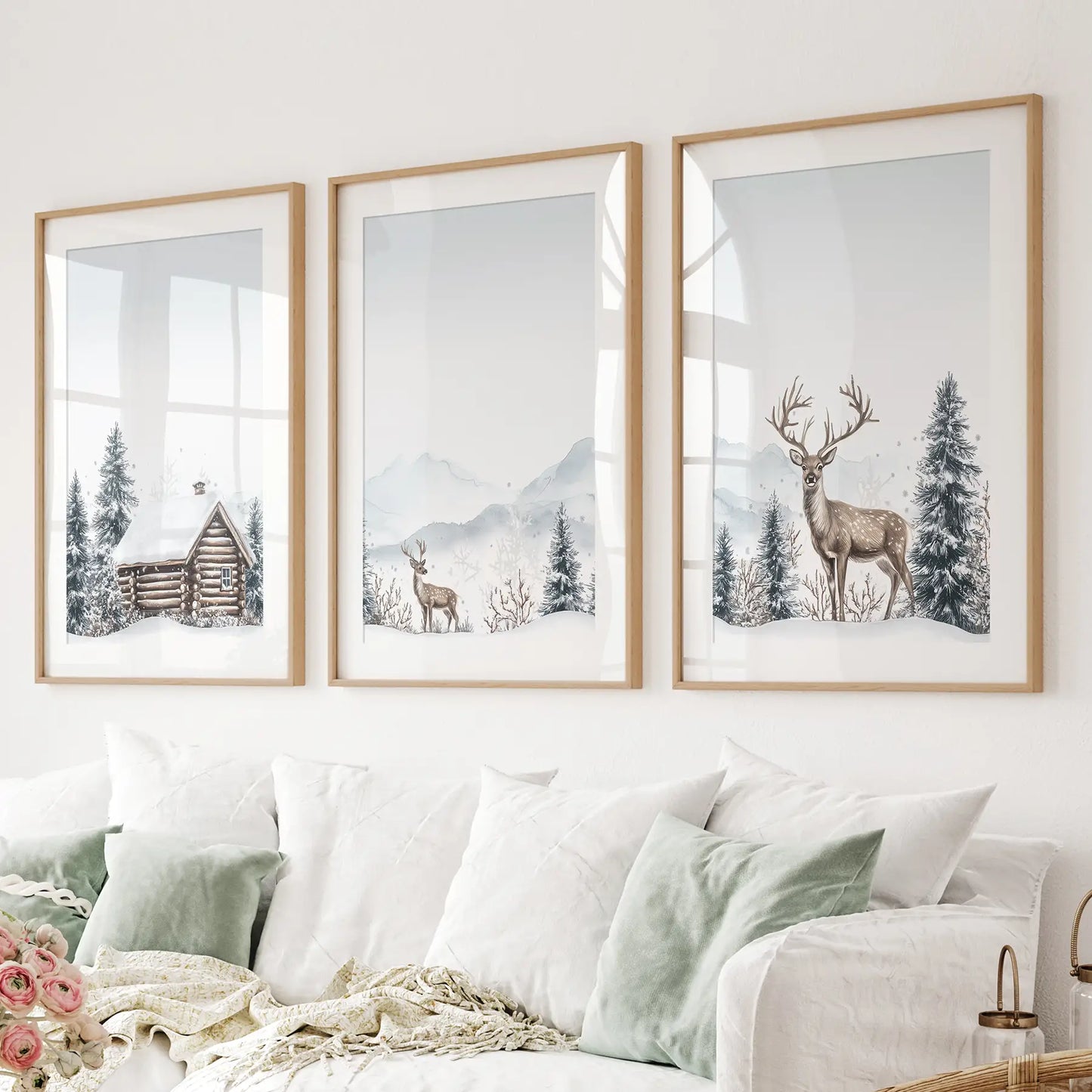 Scandinavian winter wall prints with deer and pine trees. Thinwood frames with mat above the sofa.