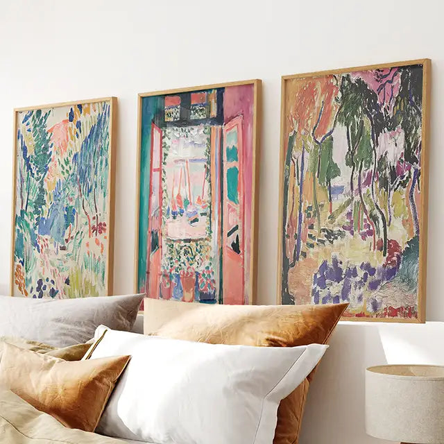 Three Matisse art prints above a bed. Trending wall art collection. Three colorful abstract paintings.