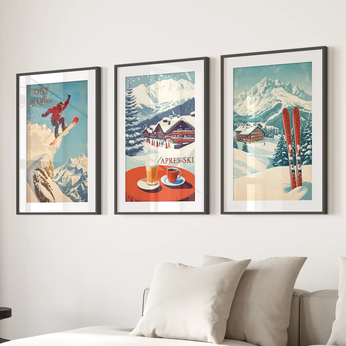 Retro ski lodge wall art with snowy peaks and ski chalet prints. Black frames with mat over the couch.