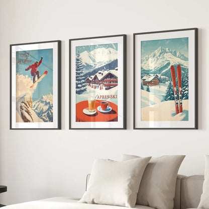 Retro ski lodge wall art with snowy peaks and ski chalet prints. Black frames with mat over the couch.