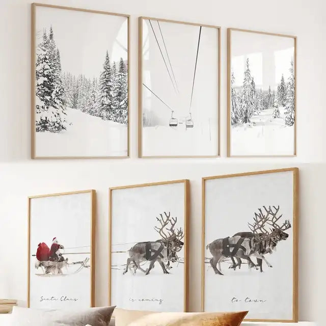 Two sets of  3 framed prints with winter ski and reindeer-themed artwork on a wall.