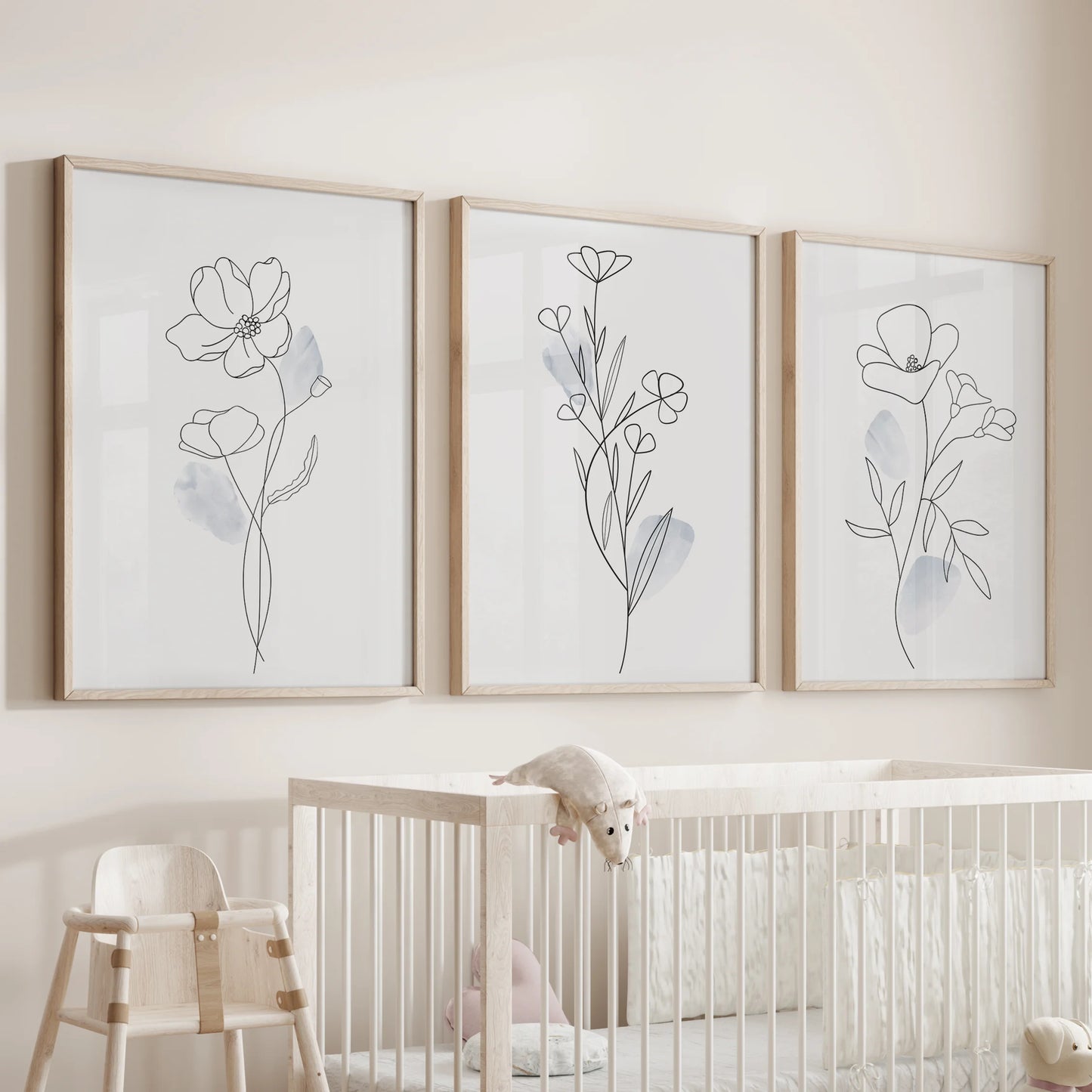 One-line flower drawings, wall art three piece set in natural wood frames, hangs over the cot to bring quiet charm to the nursery room.
