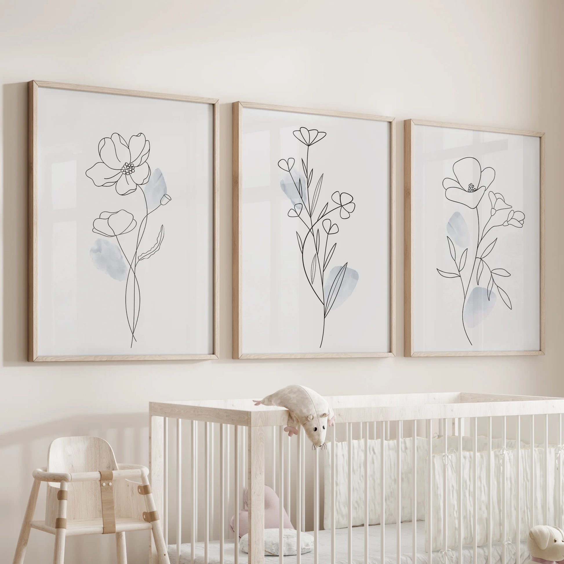 One-line flower drawings, wall art three piece set in natural wood frames, hangs over the cot to bring quiet charm to the nursery room.