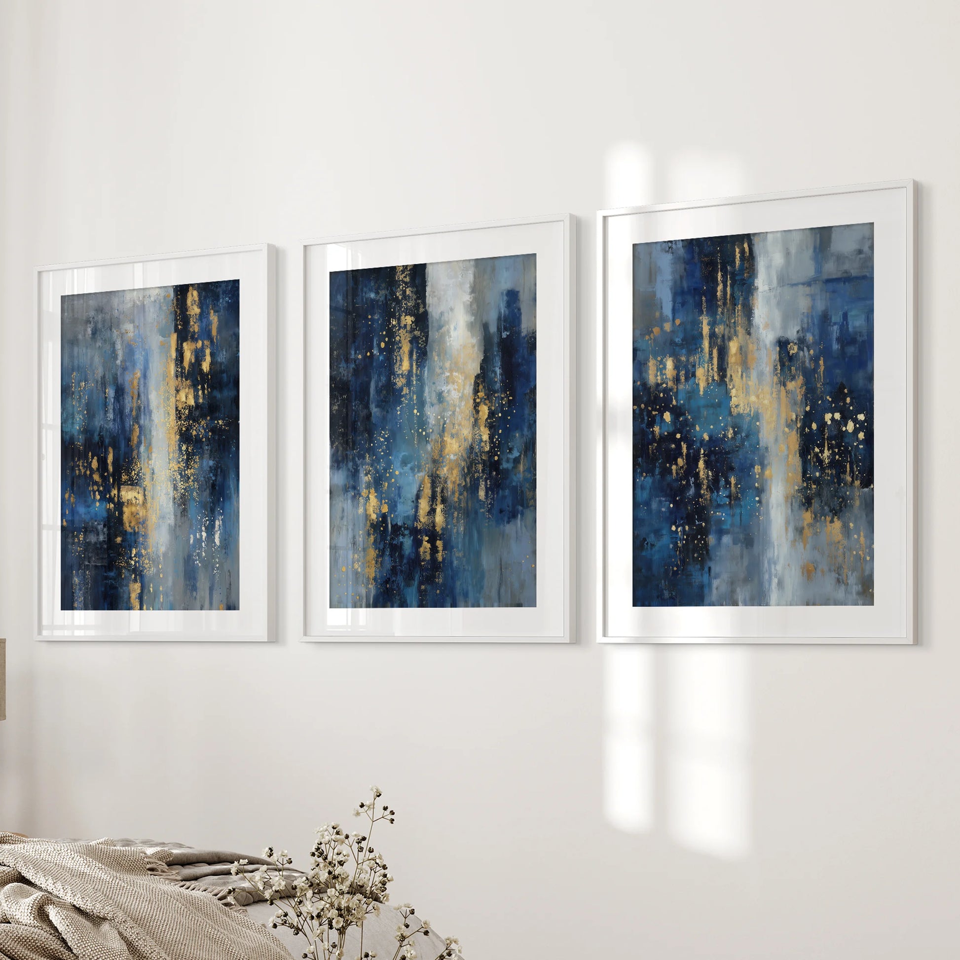 Navy blue and gold abstract brushstrokes, 3-piece wall decor set, in white matted frames gracing the bedroom wall with a refined, modern touch.