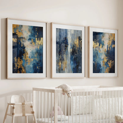 A three-piece oak-framed wall art set with gentle navy and gold shapes hangs above the nursery cot, adding soft color and warmth.