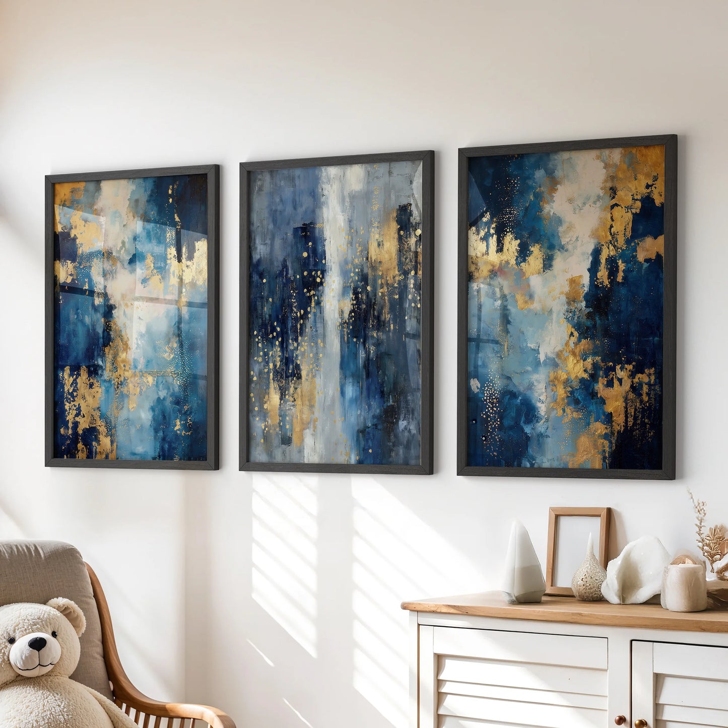 Black-framed wall art in a lively set of three blue-and-gold prints sits over the kids’ playroom dresser, bringing bold color with a clean, playful edge.