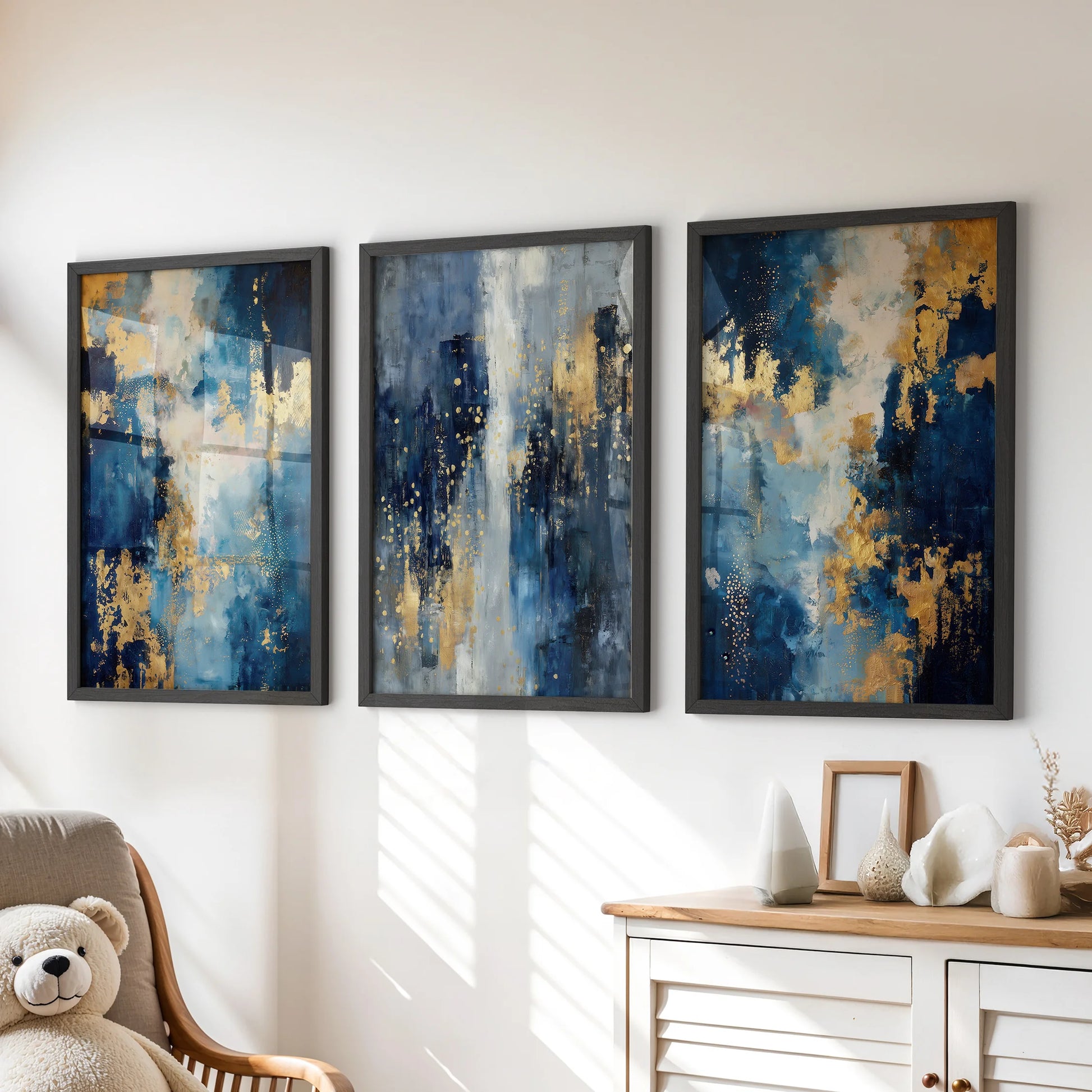 Black-framed wall art in a lively set of three blue-and-gold prints sits over the kids’ playroom dresser, bringing bold color with a clean, playful edge.